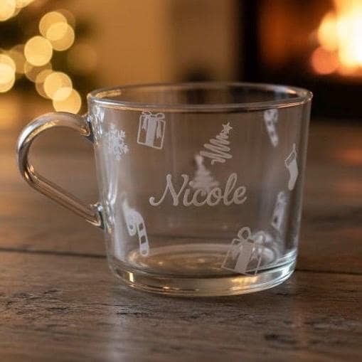Clear glass mug with the name “Nicole” and white Christmas icons