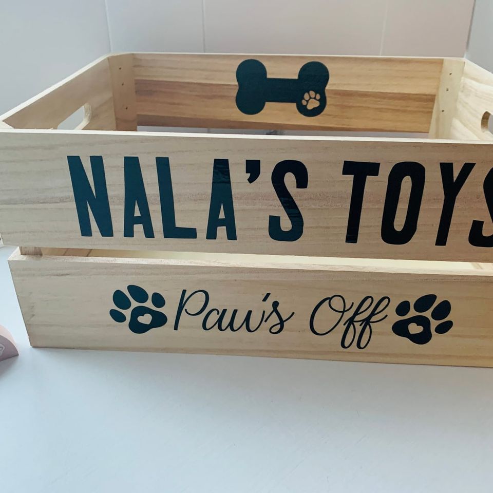 Wooden crate lettered “Nala’s Toys, Paws Off” with a bone and paw prints