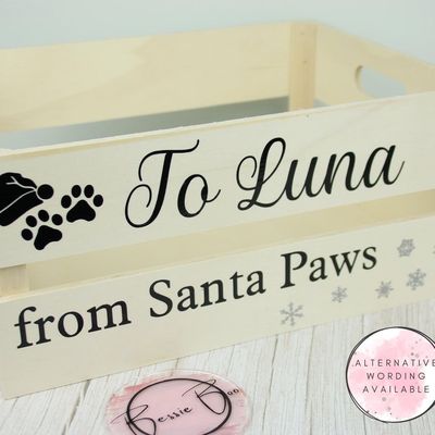 Wooden crate lettered “To Luna from Santa Paws” with a paw print wearing a Santa hat