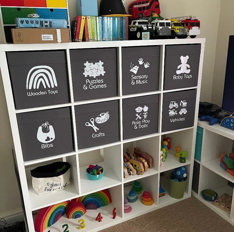 Grey cube storage boxes with white picture labels for wooden toys, puzzles, crafts and vehicles