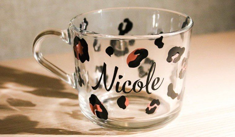 Glass mug with black and rose-gold leopard print spots and the name “Nicole”