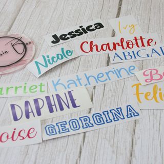 A spread of vinyl name labels in different fonts and colours: Jessica, Charlotte, Daphne, Georgina and more