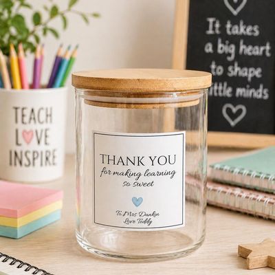 Glass jar with bamboo lid and a label reading “Thank you for making learning so sweet”