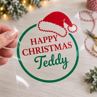 Decal reading “Happy Christmas Teddy” in red and green with a Santa hat